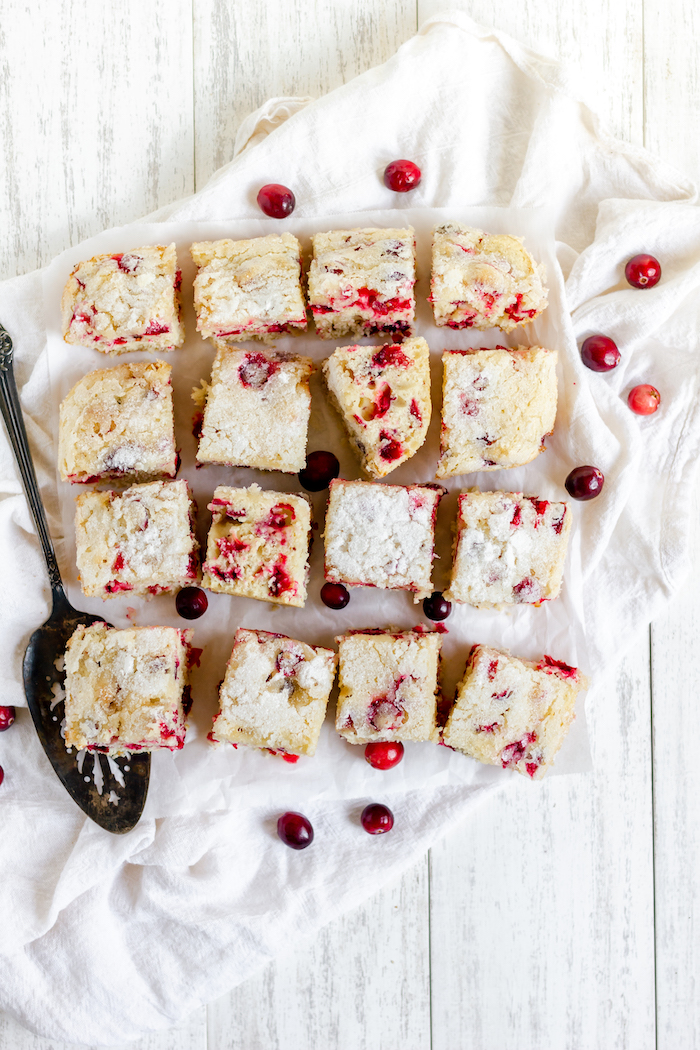 Image shows a cranberry kuchen sliced on a white towel