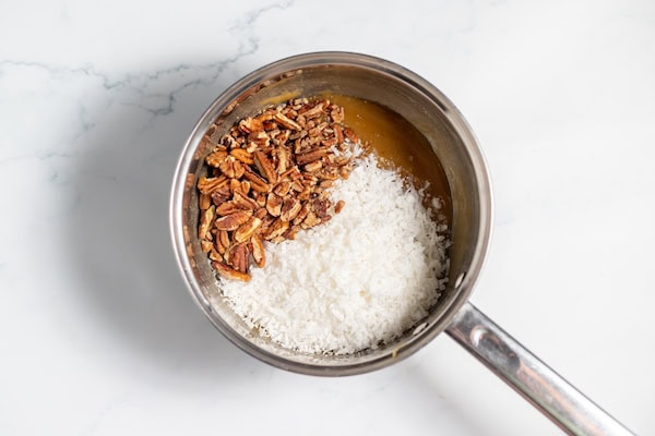 coconut and pecans in saucepan