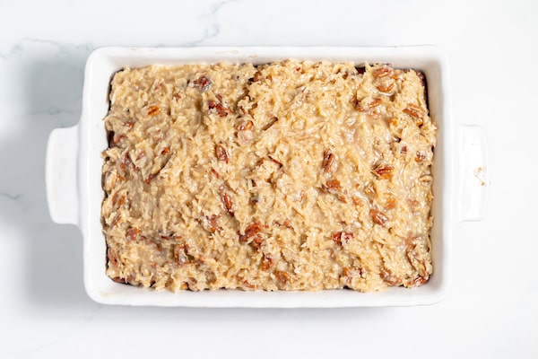 coconut pecan topping spread over oatmeal cake