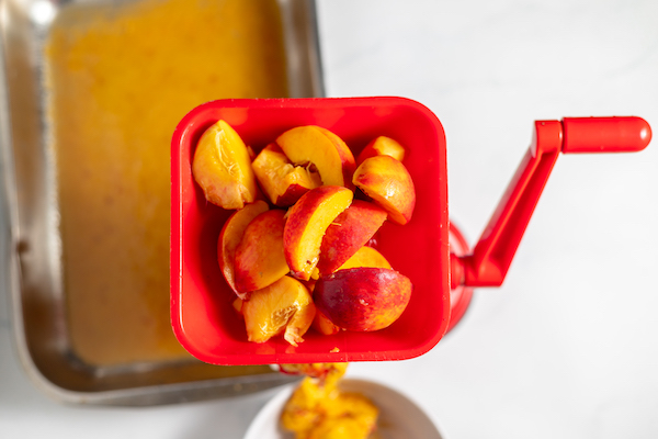 food mill pureeing peaches