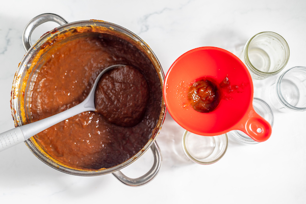 filling jelly jars with peach butter