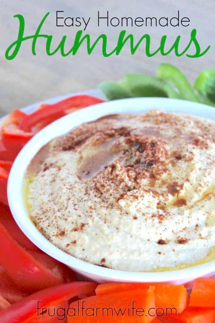 Image shows a close up of a large bowl of homemade hummus, topped with seasoning, with text above that reads "Easy Homemade Hummus"
