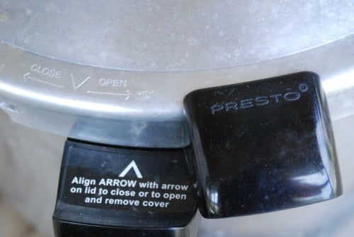 Image shows a close up of the cover of a pressure cooker