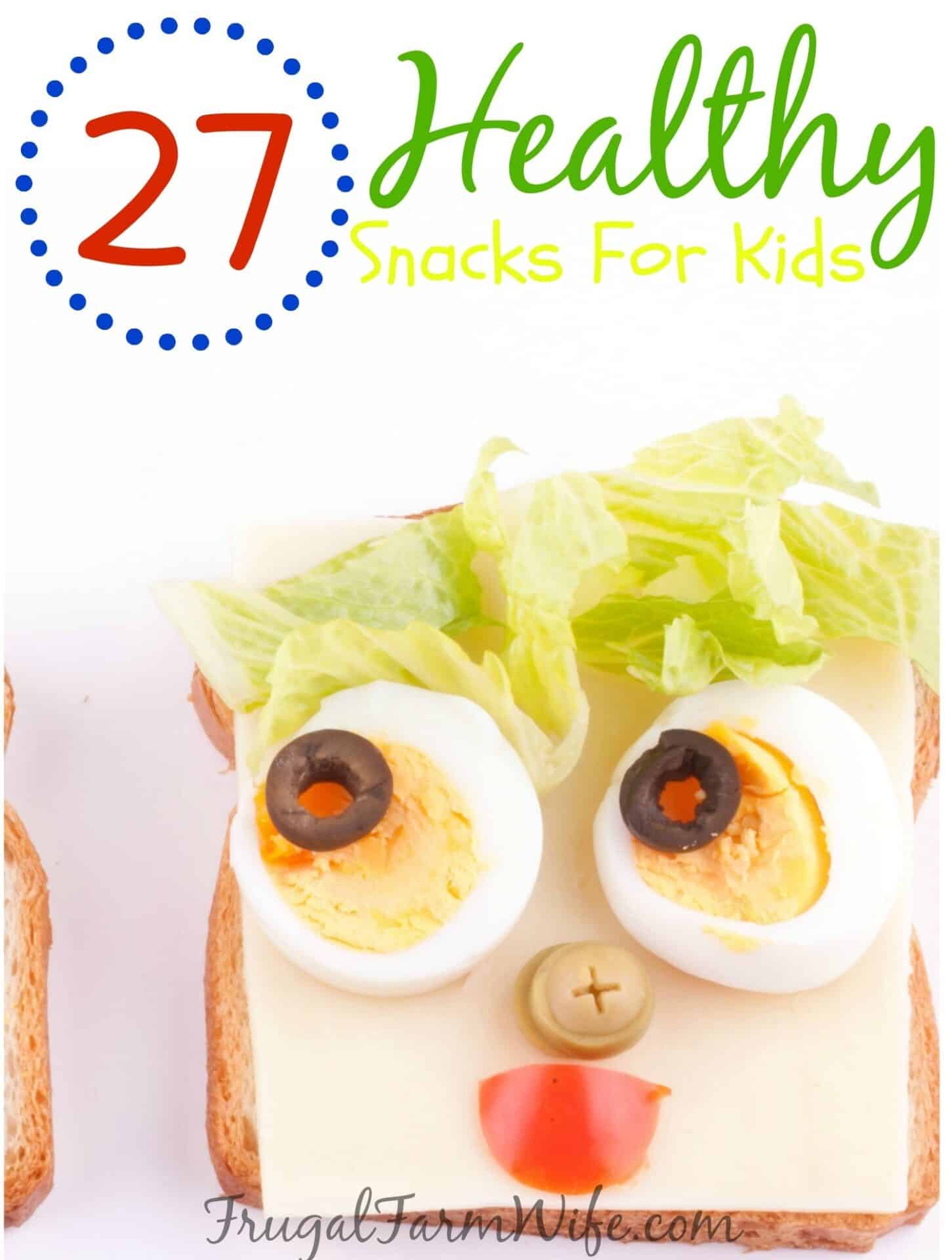 Image shows an open faced sandwich made with cheese, egg, lettuce and olives to look like a face on the bread. Text above reads "27 Healthy Snacks for Kids"