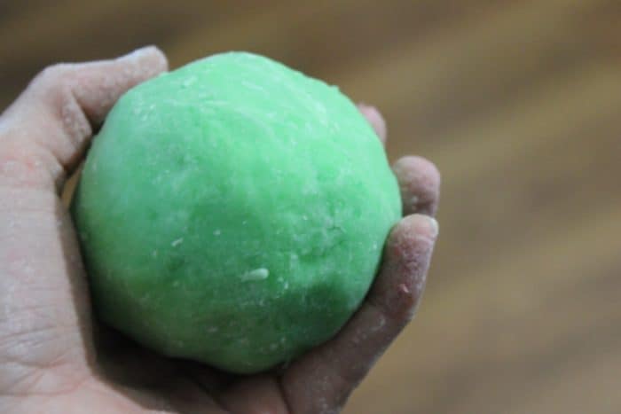 Image shows a hand holding playdough