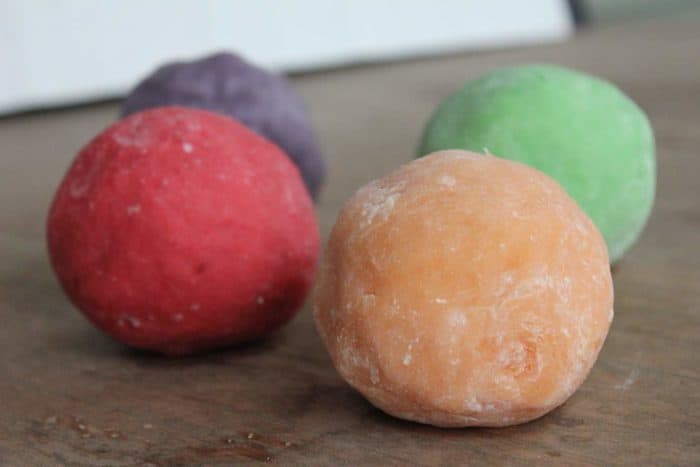 Photo shows four balls of playdough on a table
