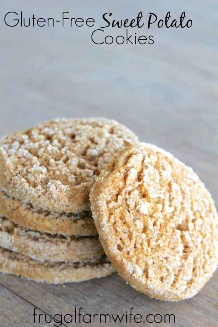Image shows a close up of a stack of gluten free sweet potato cookies on a table. One cookie is leaning against the rest of the stack. 