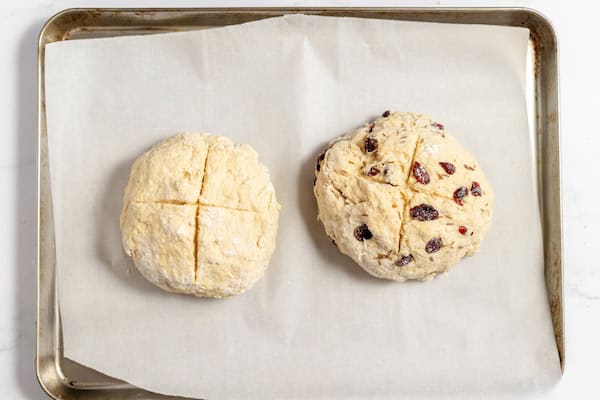 dough with cross shape cuts ready to bake