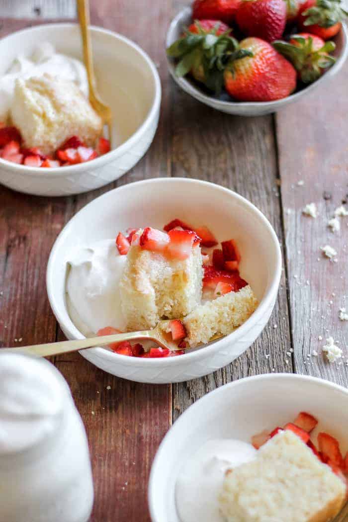 Photo shows several bowls of strawberry shortcake on a table 