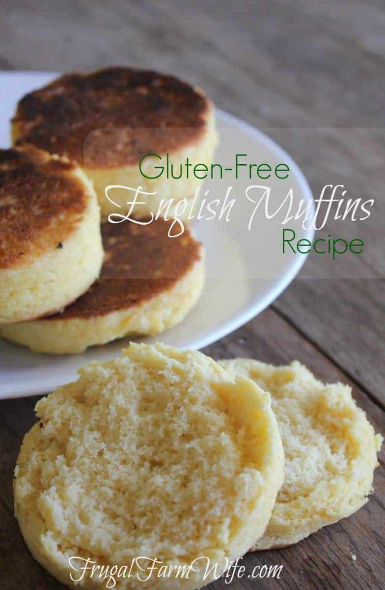 A plate of gluten-free English Muffins sit on a table in the background with a sliced English muffin in the front. Text above reads  "Gluten-Free English Muffins Recipe"