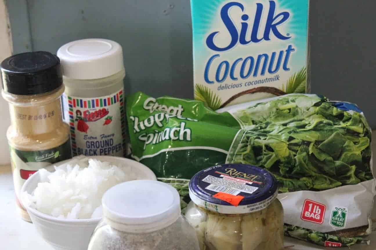 Photo shows all the ingredients you'll need to make skinny spinach artichoke dip: seasonings, spinach, coconut milk, and more. 