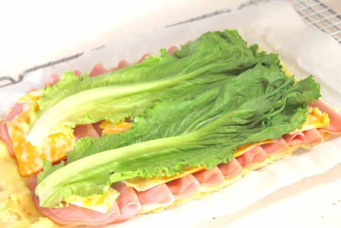 Photo shows ingredients for a sandwich wrap laid out on a paper towel