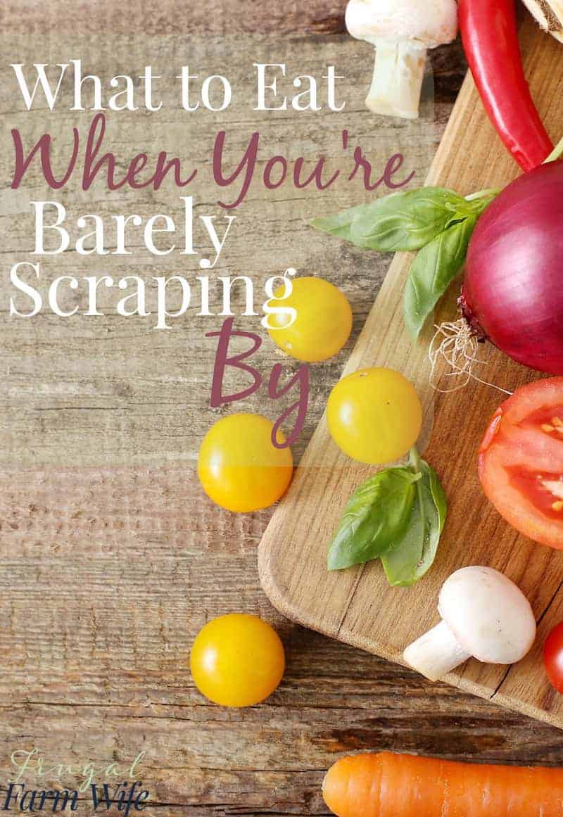 Image shows a cutting board with onion, tomato, cherry tomatoes on a counter. Text reads "What to eat when you're barely scraping by" 