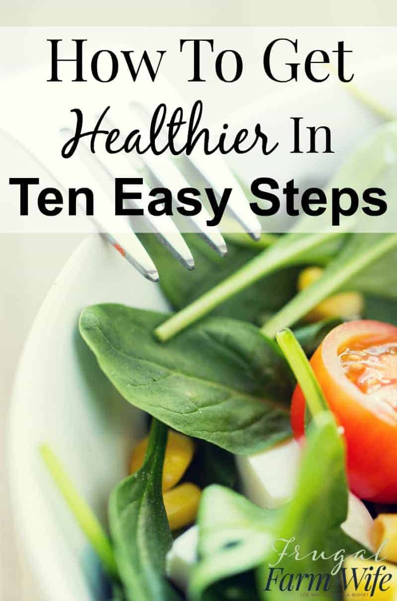 Image shows a close up of a spinach salad with a fork in it with text overlay that reads "How to Get Healthier in Ten Easy Steps"