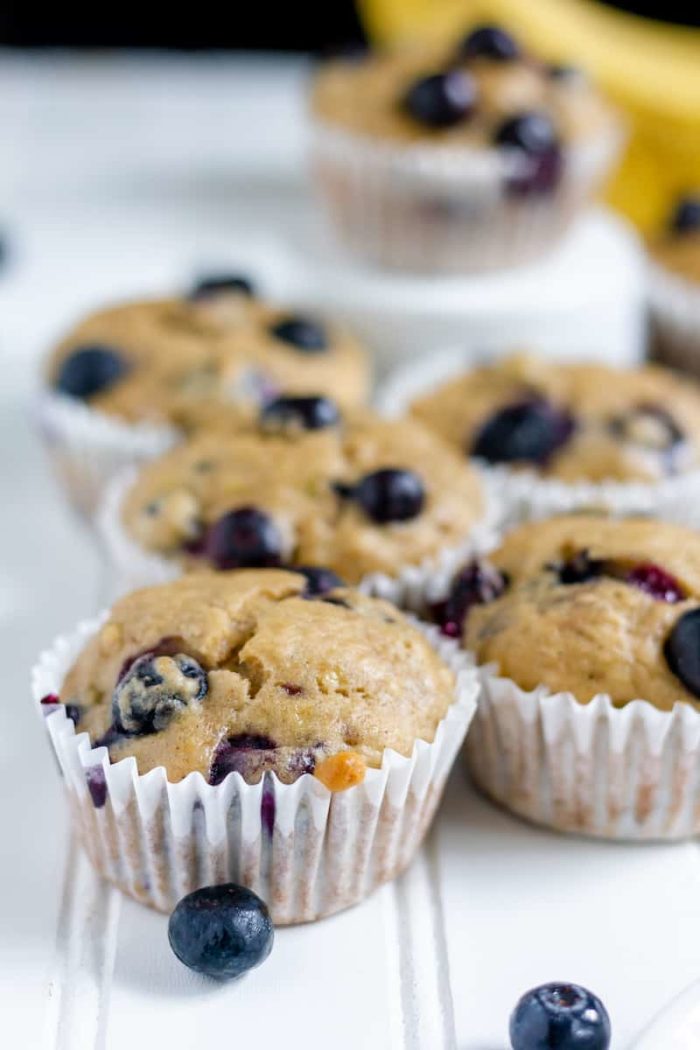 Image shows several blueberry muffins close up