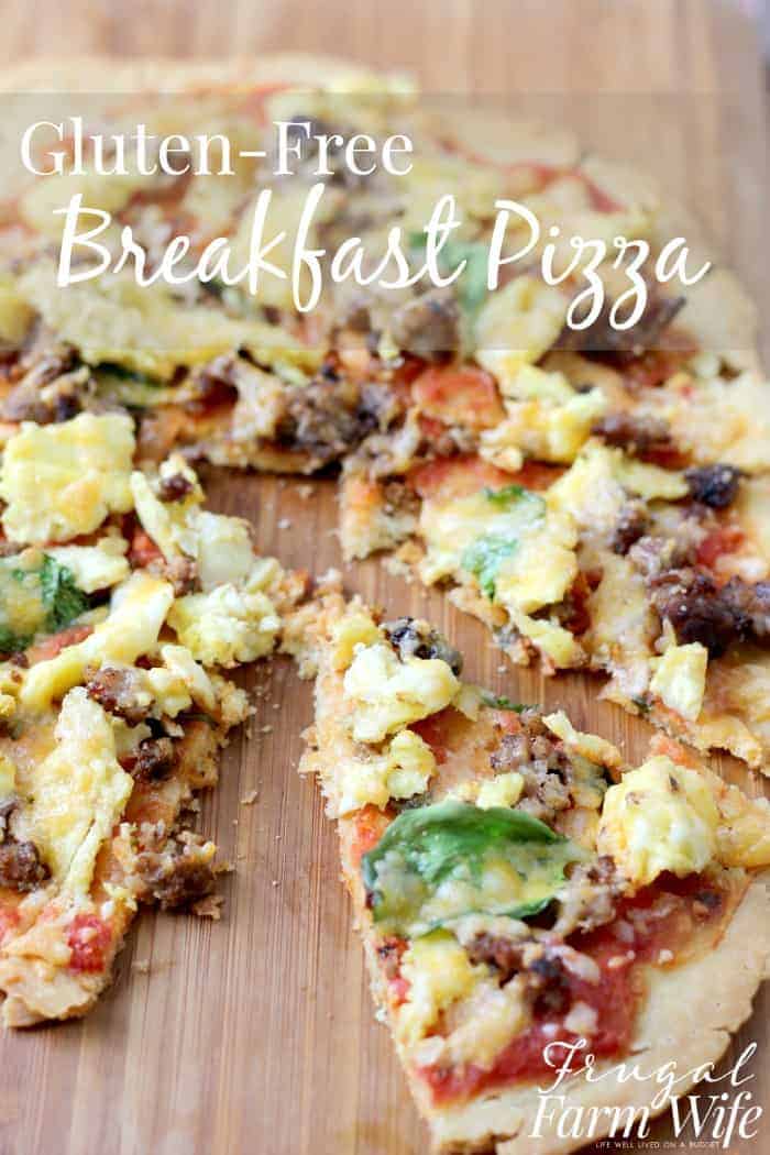 Image shows a large breakfast pizza with egg, sausage, spinach and more cut into slices. Text overlay reads "Gluten-free Breakfast Pizza"