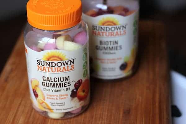 Images shows two bottles of Sundown Naturals gummies on a table