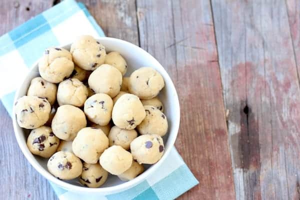 Image, taken from above,  shows a bowl of protein balls on a table. 