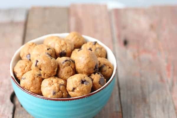 Image shows a bowl of carrot cake protein balls on a table. 