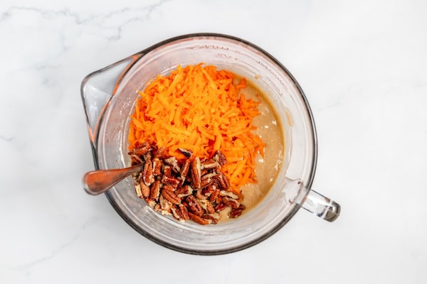 carrots and pecans added to bowl of carrot cupcake batter