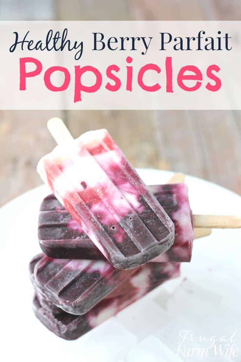 Image shows several yogurt berry parfait popsicles stacked on a white plate. Text above reads "Healthy Berry Parfait Popsicles"