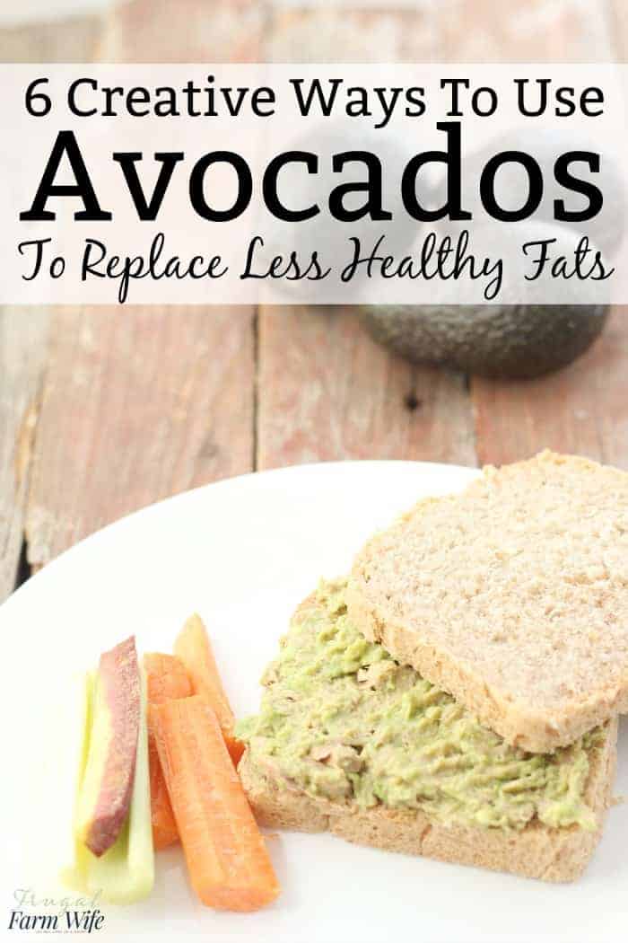 Photo shows a close up of a white plate. Avocado tuna salad is on two pieces of bread, with cut up carrots and celery next to it. Text overlay reads "6 Creative Ways to Use Avocados to Replace Less Healthy Fats"