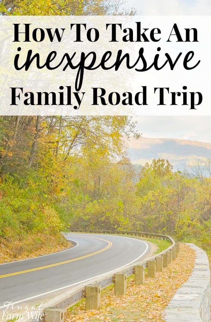Image shows a winding road along the side of some mountains in the fall, with text that reads "How to Take an Inexpensive Family Road Trip"