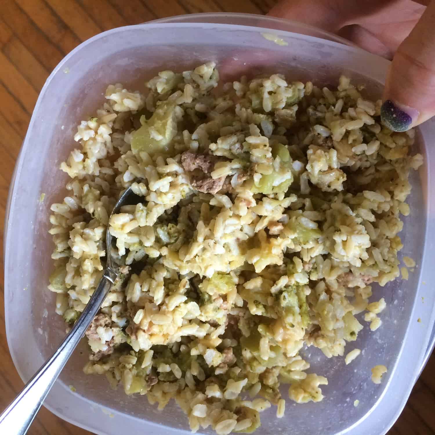 Image, taken from above, shows a Rubbermaid container of rice and broccoli casserole