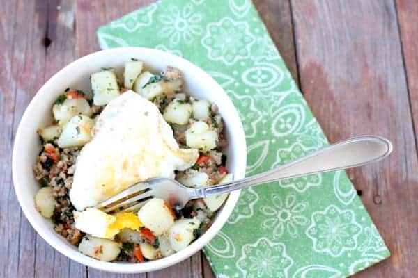 Image shows a fork in a southwest breakfast bowl on a table 