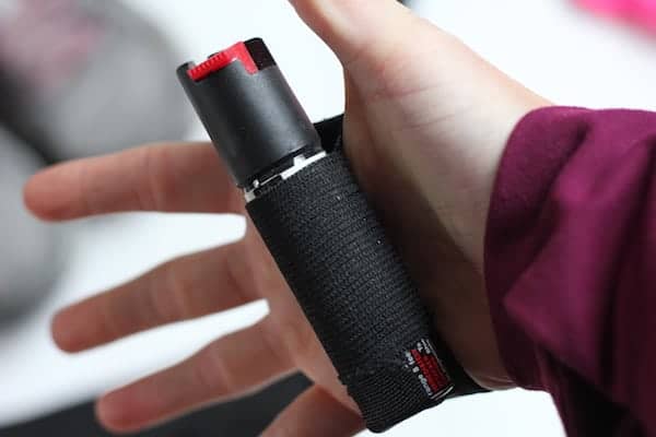 Image shows a hand with pepper spray wrapped around the palm.