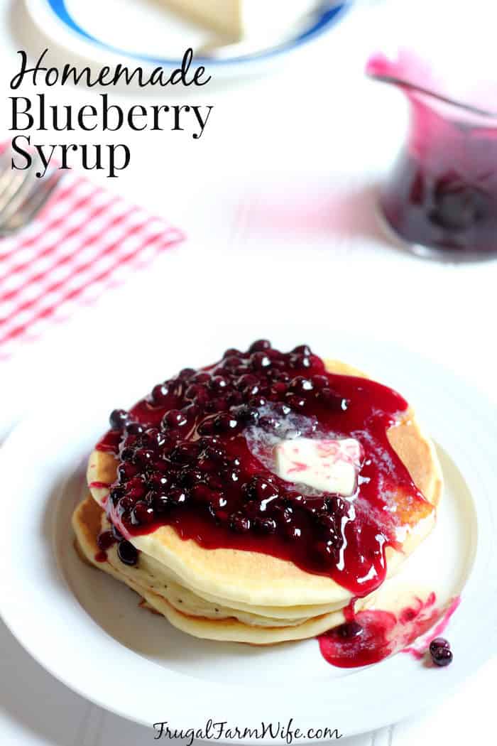 Photo shows a stack of pancakes with blueberry syrup and text that reads "Homemade Blueberry Syrup"