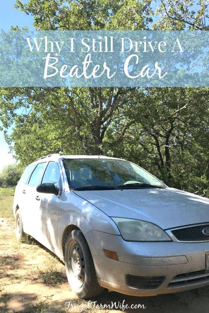 Image shows a car parked under a tree with text that reads "Why I still drive a beater car"