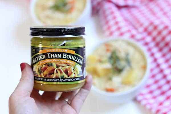 Image shows a hand holding a jar of Better Than Bouillion chicken base