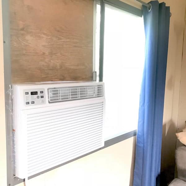 Image shows an air conditioner inside the window of a mobile home