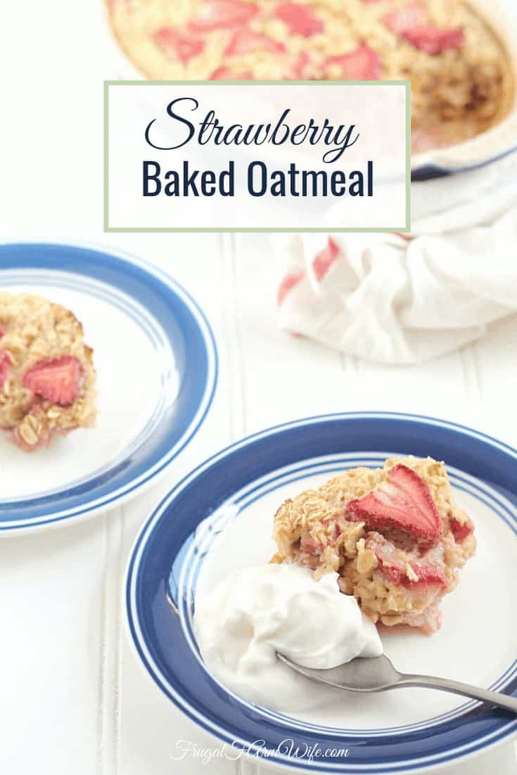 Image shows two white plates with blue trim on a table, each with a piece of strawberry baked oatmeal on them. In the background is a pan of strawberry baked oatmeal