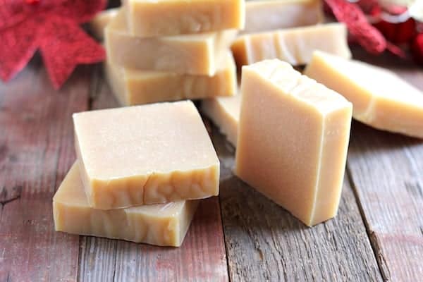 Image shows several bars of homemade soap piled on a table
