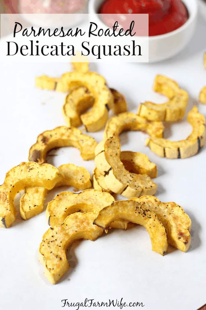 Image shows pieces of roasted squash on a counter with text that reads "Parmesan Roasted Delicata Squash"