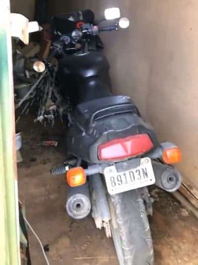 Photo shows a motorcycle in a garage