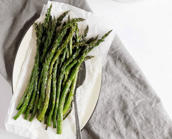 Photo shows a plate of roasted asparagus