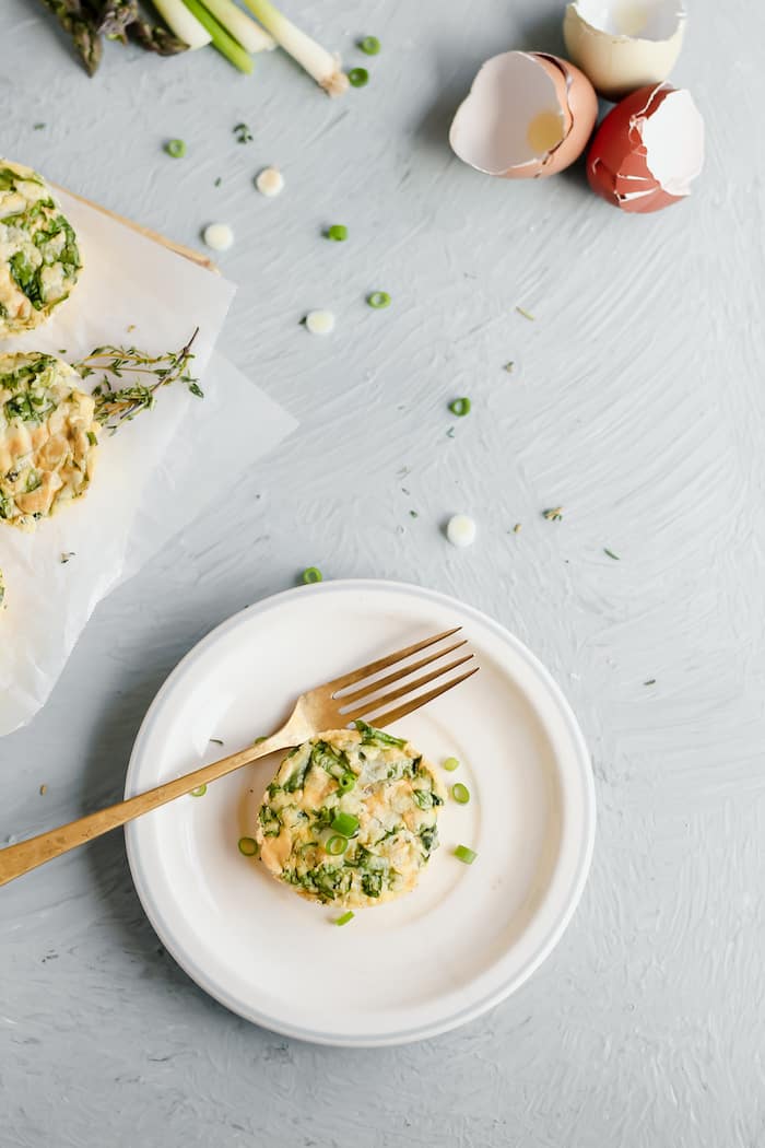 Image shows a white plate with a small veggie egg bite on it