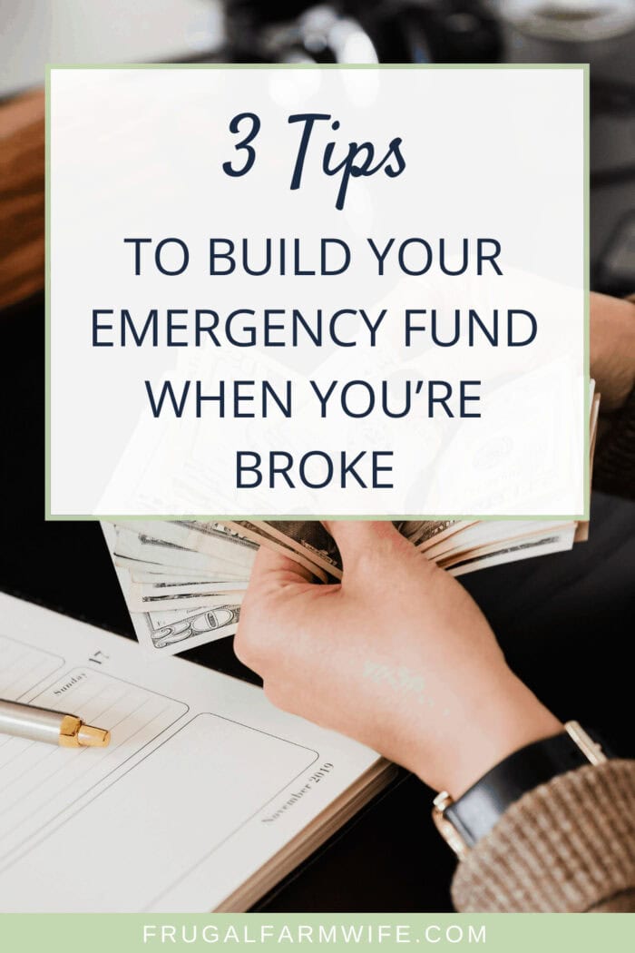 Image shows a hand holding money, with text that reads "3 Tips To Build Your Emergency Fund When You're Broke"