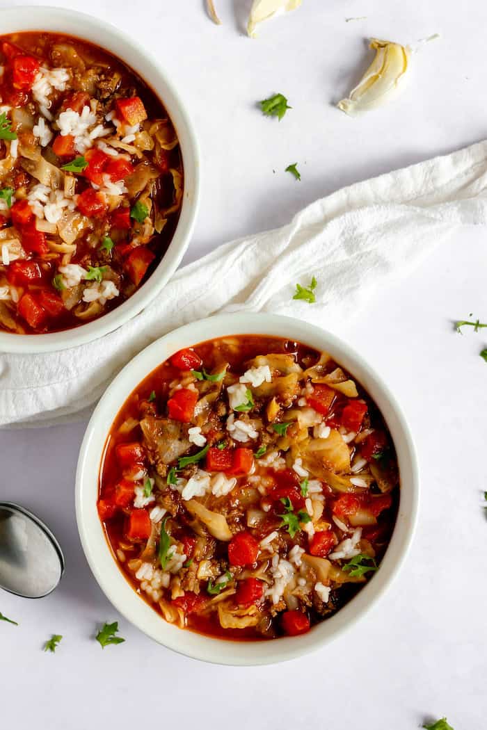 Image shows two bowls of stuffed cabbage soup on a table