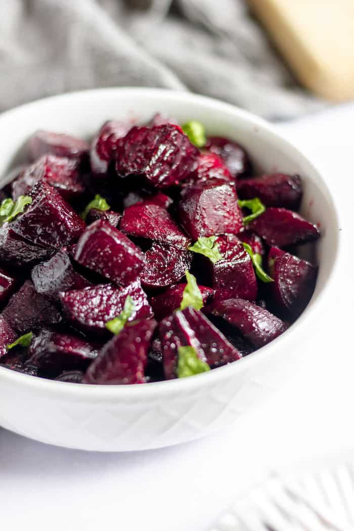 Image shows roasted balsamic beets ready to serve in a bowl.