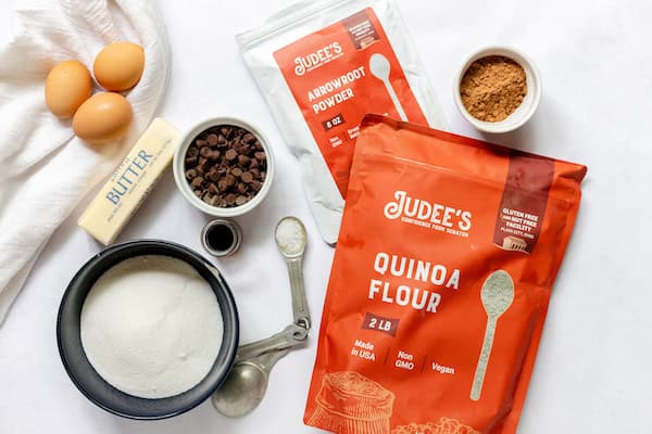 Image, taken from above, shows the ingredients needed to make gluten free brownie bites- eggs, butter, chocolate, sugar, gluten free flours