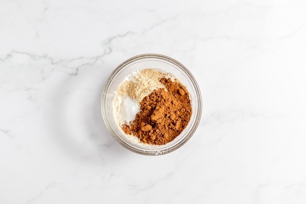 Image shows a glass bowl with dry ingredients in it