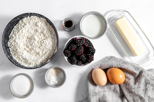 Image, taken from above, shows the ingredients for blackberry scones set out all together and ready to go.
