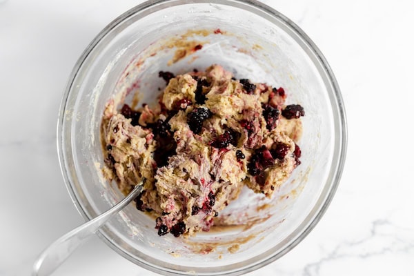 Image, taken from above shows the dough for scones with blackberries stirred in