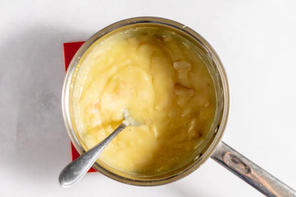 Image, taken from above, shows a pot with the coconut cream pie filling ready to be put in the pie shell