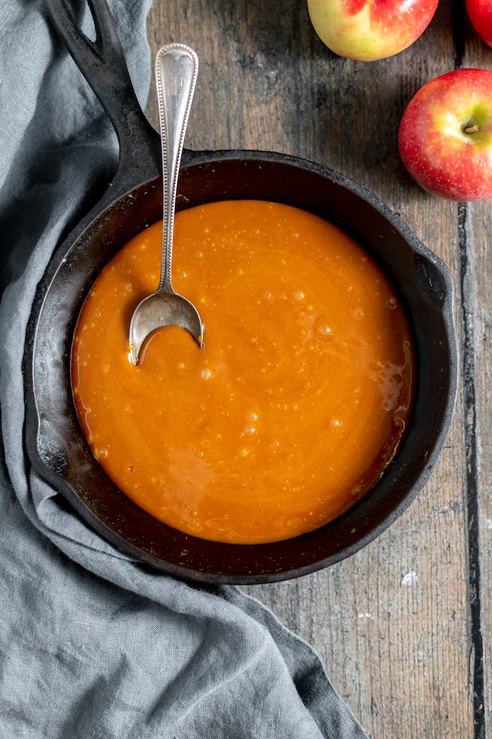 Homemade caramel sauce in a cast iron skillet