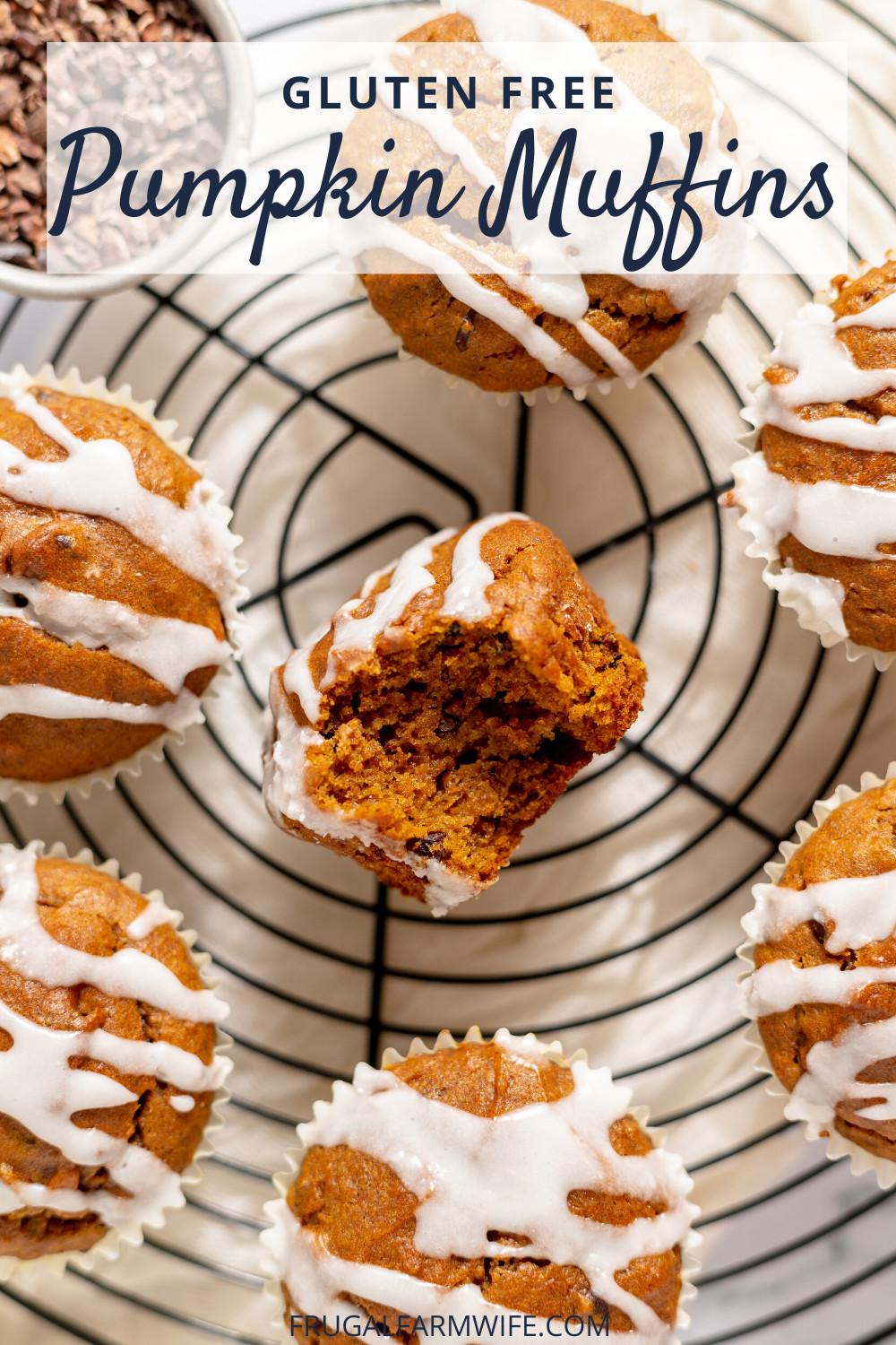 Image, taken from above, shows several gluten-free pumpkin muffins with vanilla glaze drizzled on them on a cooling rack. The center muffin is turned on its side with a bite taken out of it. Text above reads "Gluten Free Pumpkin Muffins"